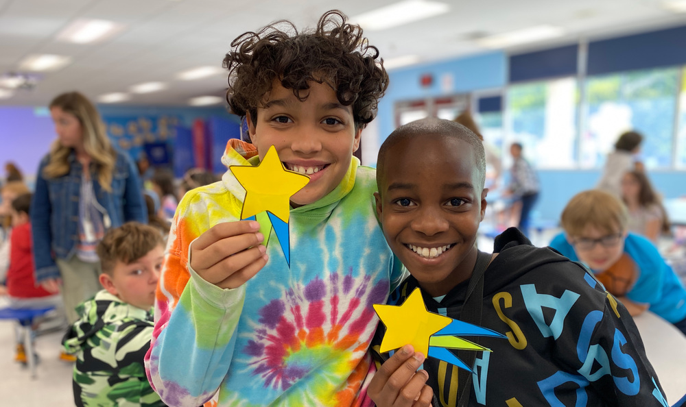 Students holding paper stars